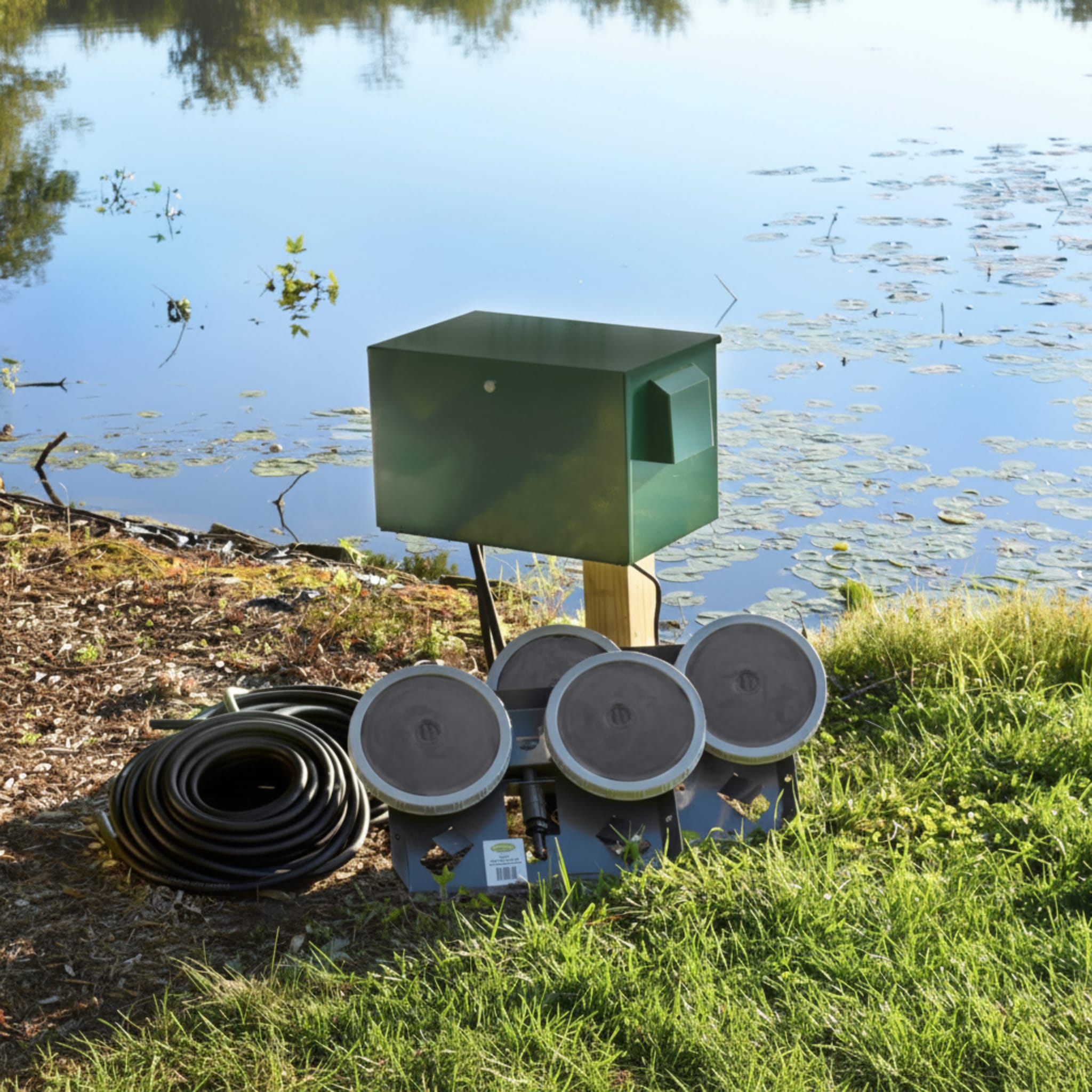 Large Pond Aerator system with dual diffusers and hose near pond for efficient oxygenation.