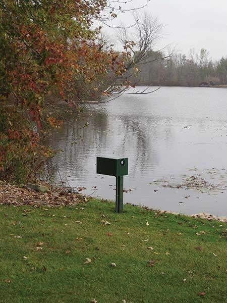 Large Pond Aerator post mount cabinet displayed near serene lake with autumn foliage.