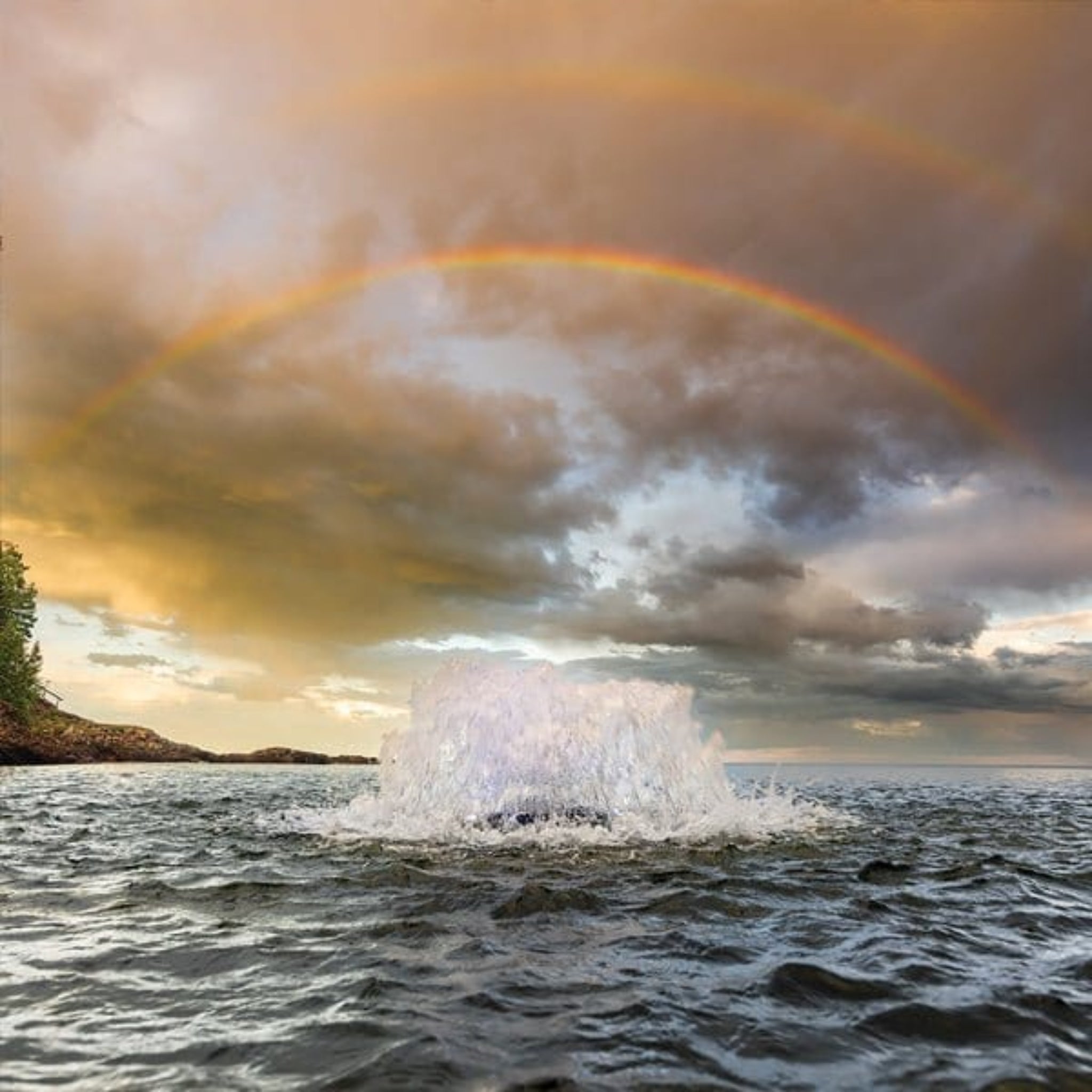 Kasco Surface Aerator 1/2 HP generating oxygen in water with rainbow in the background